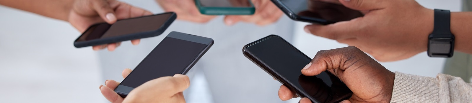 hands holding smartphones