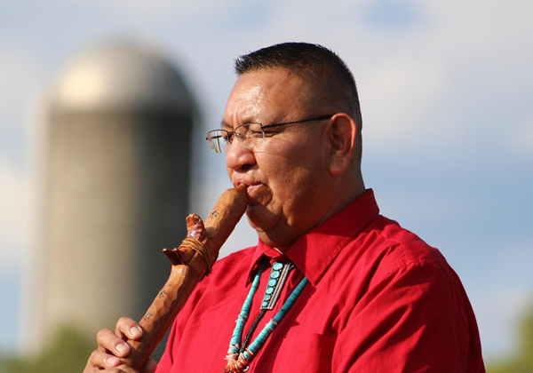 Photo of Fred Nez Keams playing a Native American flute
