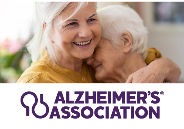 Photo of two women hugging & the Alzheimer's Association logo